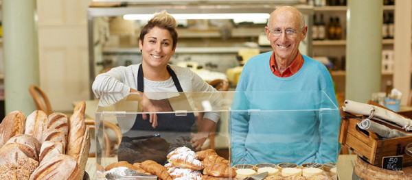 A young woman and older man operating a bakery business