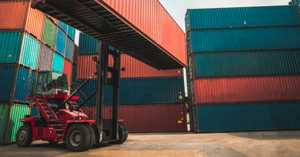 Forklift in front of shipping containers